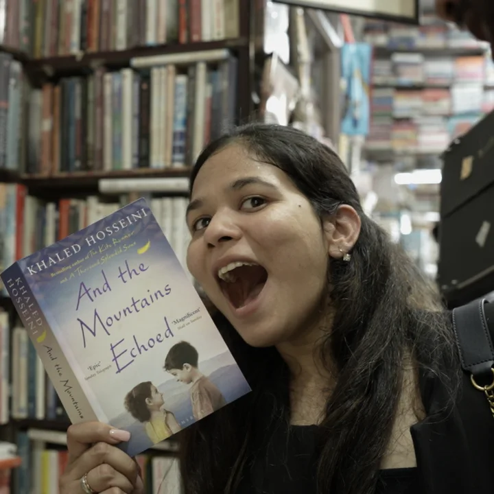 Holding a book in a bookshop