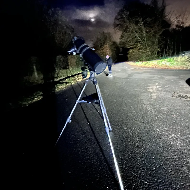 My telescope set up on a road at night